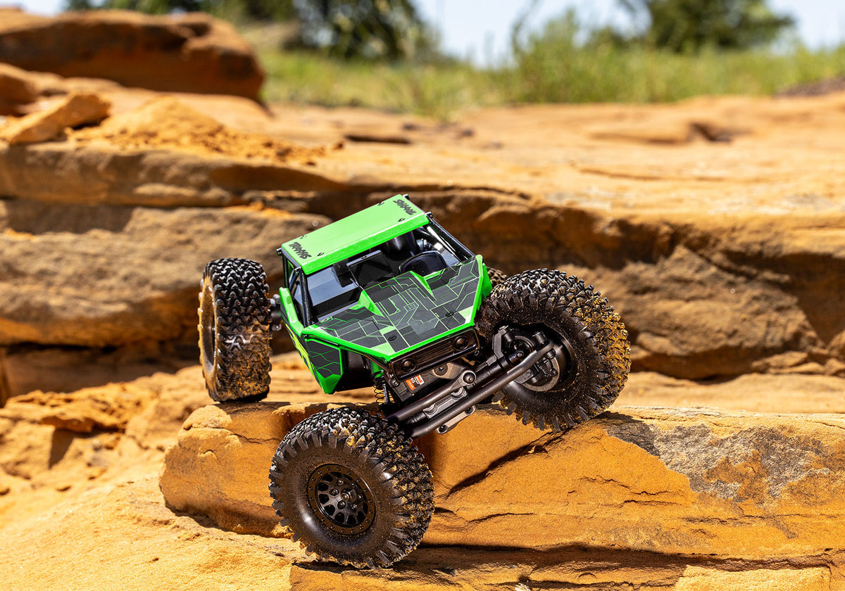 Green TXC-4M crawling on the trail