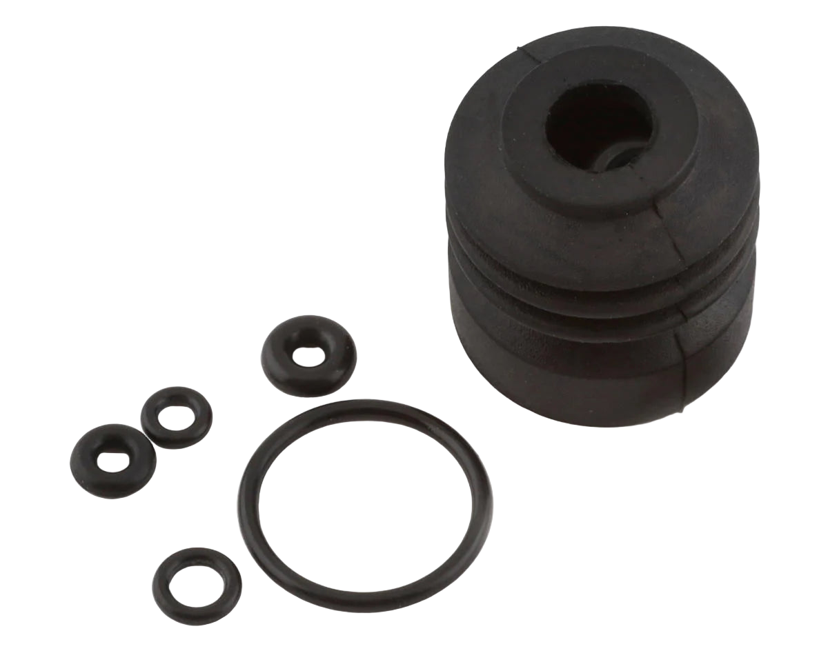 A set of black carburetor O-rings and small rubber parts, presumably for a model airplane engine.