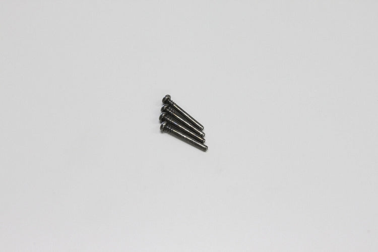 A set of four metal screw pins laid out against a light background.