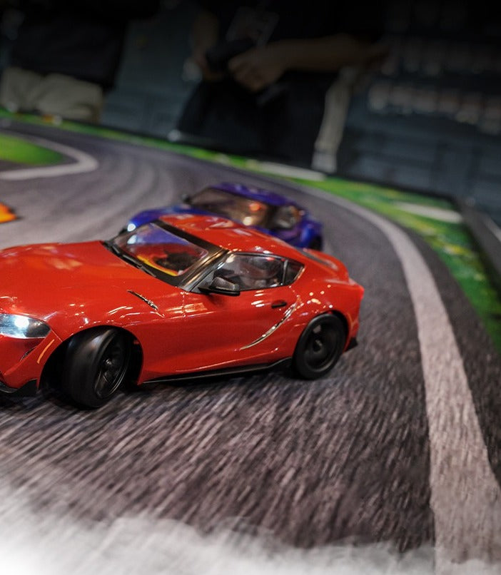 HPI Stage-D24 2024 Toyota GR Supra in Prominence Red drifting on track