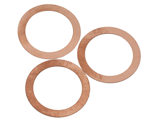 Three copper head gasket shims arranged in an overlapping fashion.
