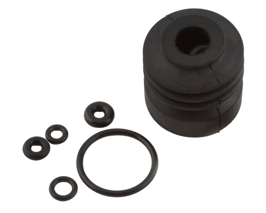 A set of black carburetor O-rings and small rubber parts, presumably for a model airplane engine.